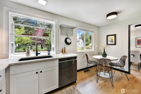 a kitchen with a table chairs stove and sink