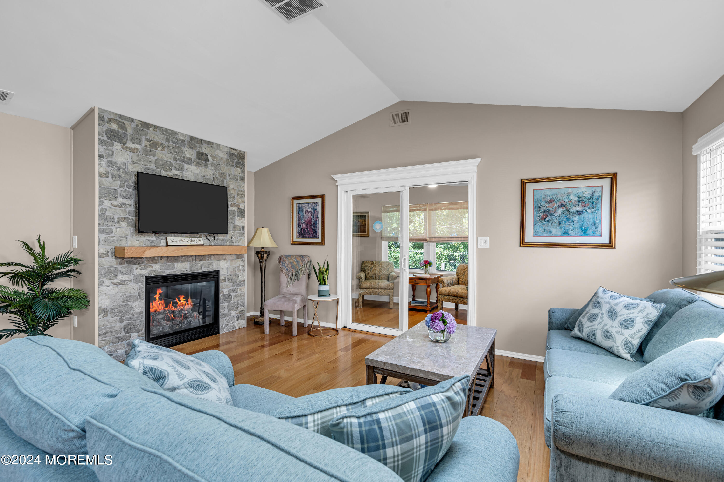 8 Deer Run Lane Brick, NJ 08724 - Photo 16 of 42 a living room with furniture a fireplace and a flat screen tv