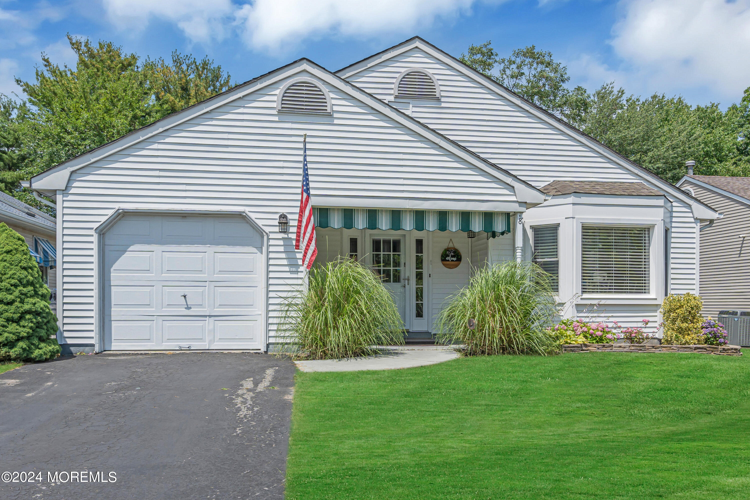8 Deer Run Lane Brick, NJ 08724 - Photo 2 of 42 a view of a white house with a small yard plants and a large tree