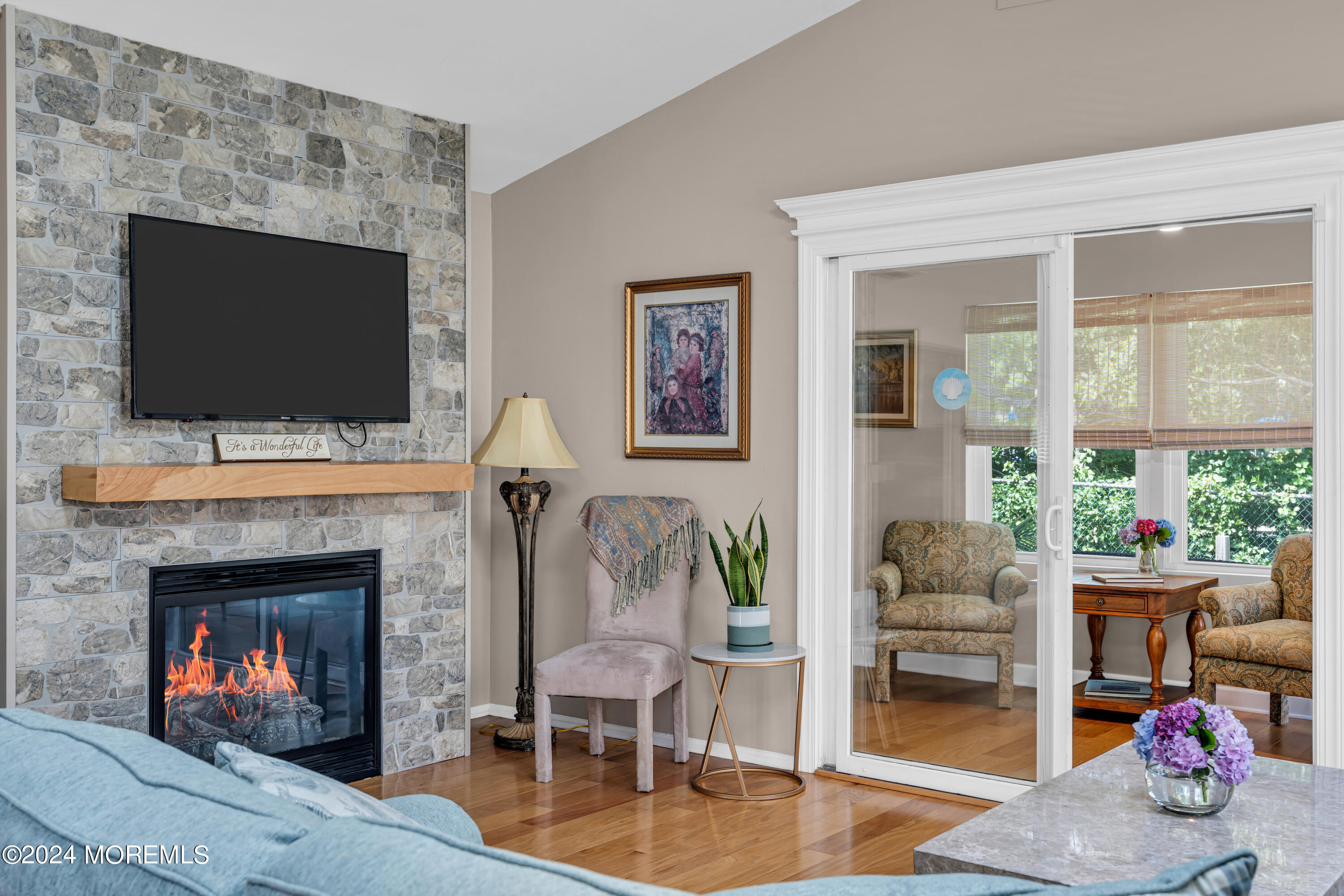 8 Deer Run Lane Brick, NJ 08724 - Photo 21 of 42 a living room with furniture a flat screen tv and a fireplace