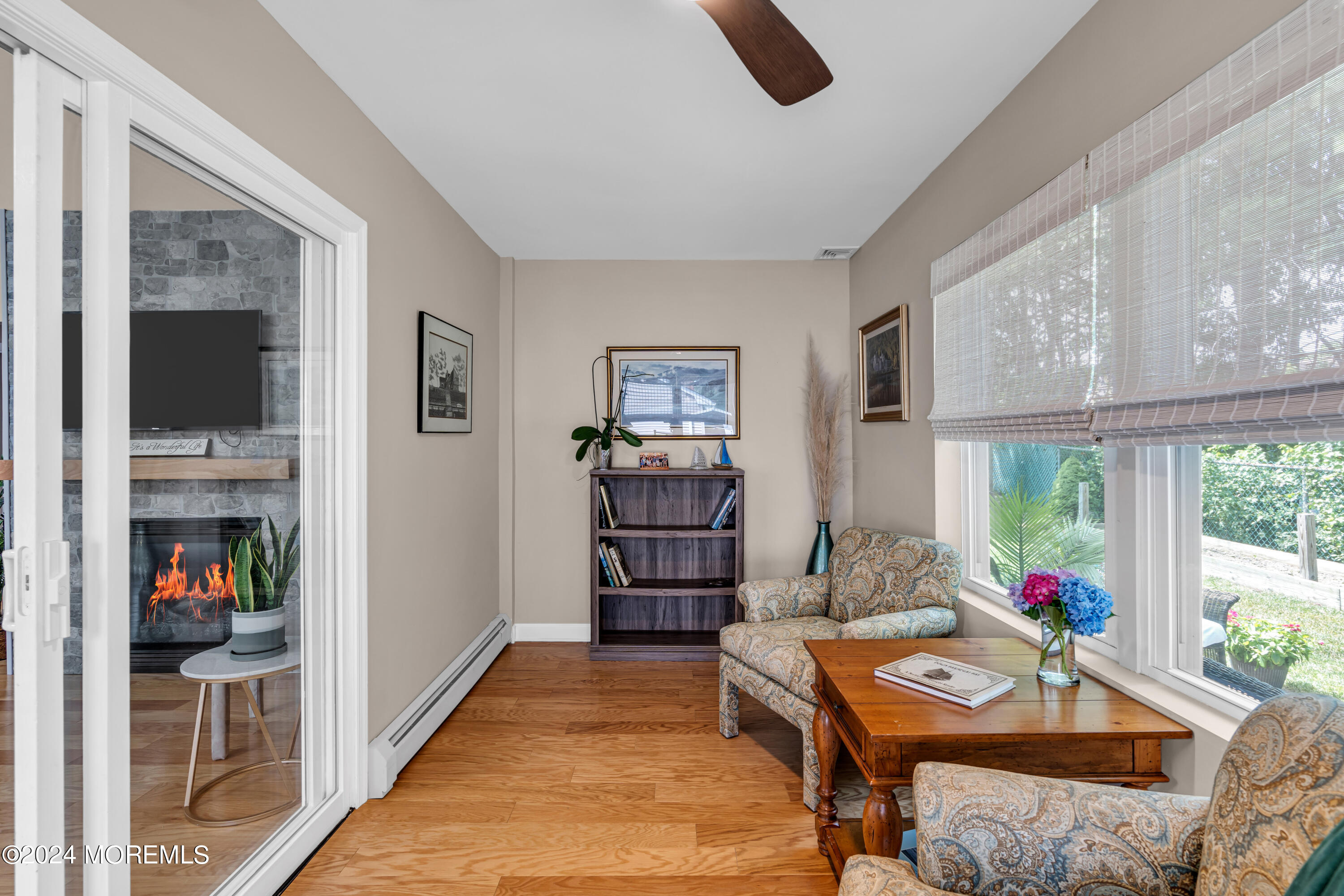 8 Deer Run Lane Brick, NJ 08724 - Photo 23 of 42 a living room with furniture a flat screen tv and a floor to ceiling window