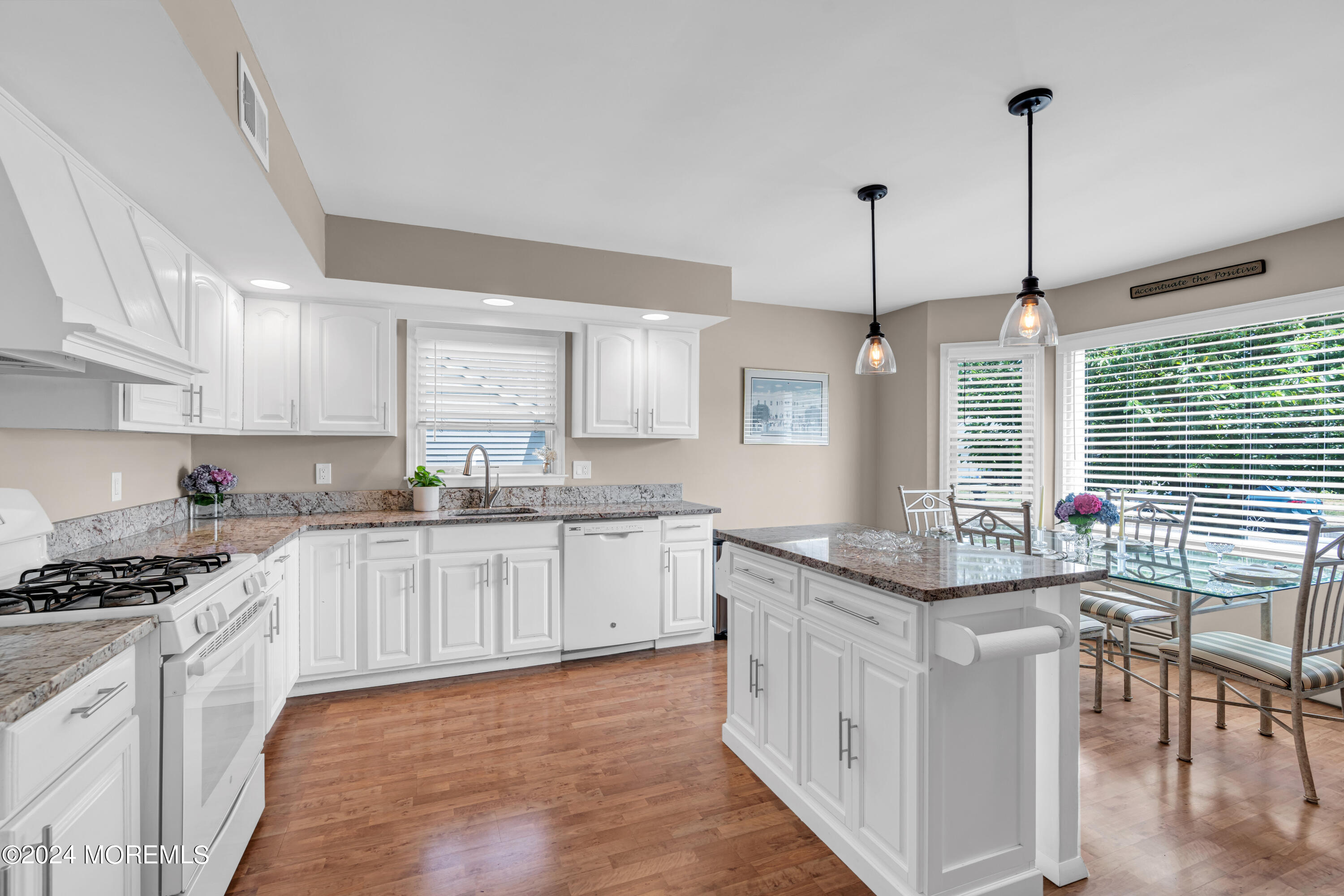 8 Deer Run Lane Brick, NJ 08724 - Photo 8 of 42 a kitchen with stainless steel appliances granite countertop a stove a sink dishwasher a refrigerator and white cabinets with wooden floor