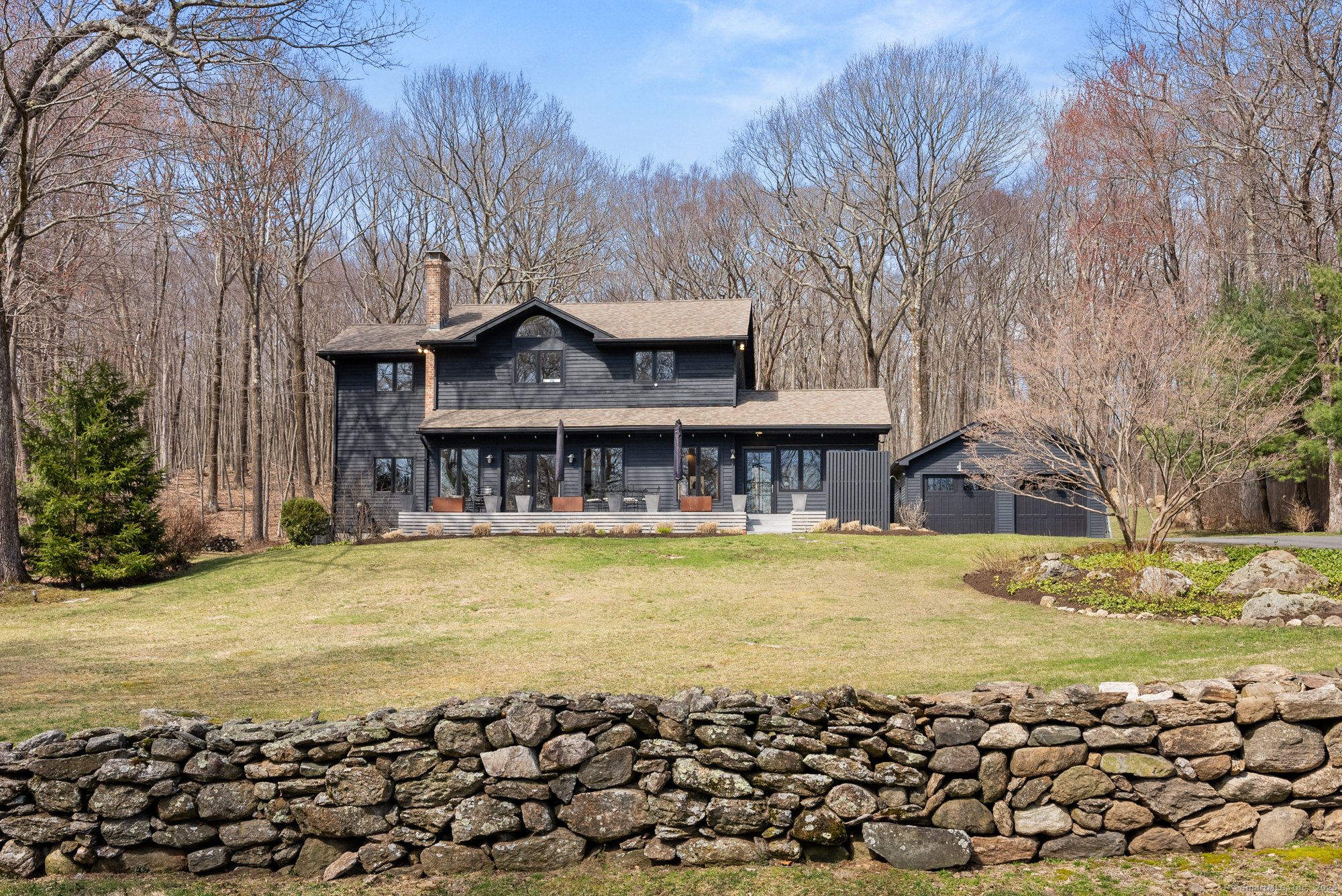 a front view of house with yard and seating space
