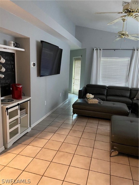 606 Robert Avenue Lehigh Acres, FL 33936 - Photo 13 of 14 a living room with a couch and a flat screen tv