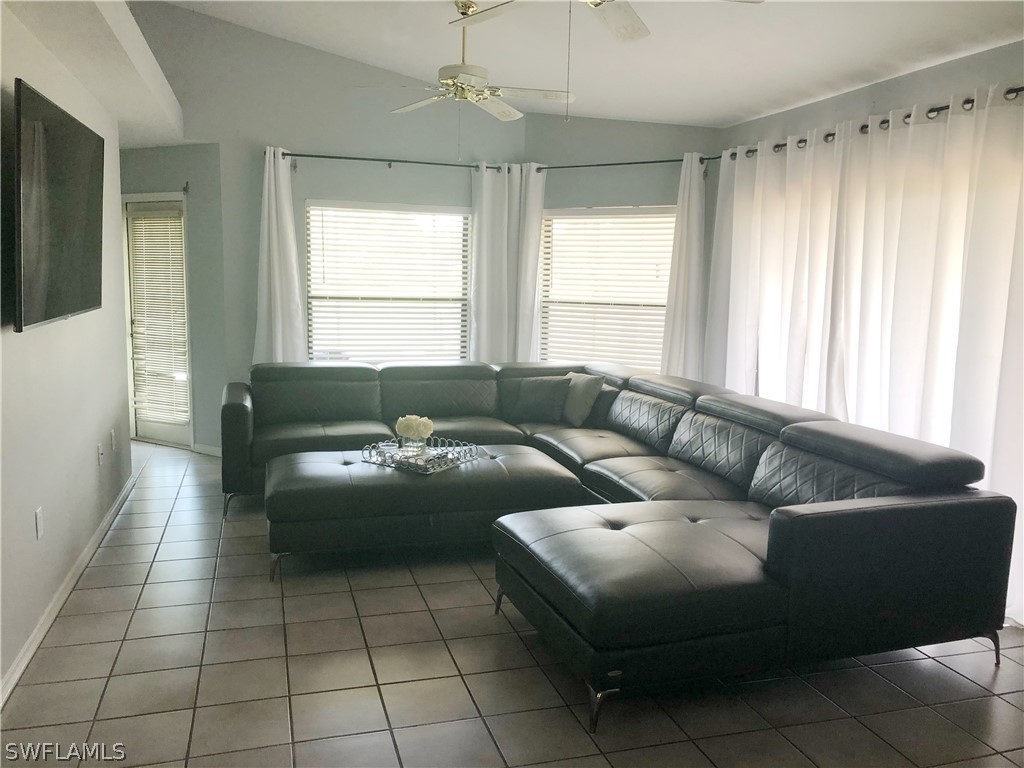 606 Robert Avenue Lehigh Acres, FL 33936 - Photo 2 of 14 a living room with furniture and a large window