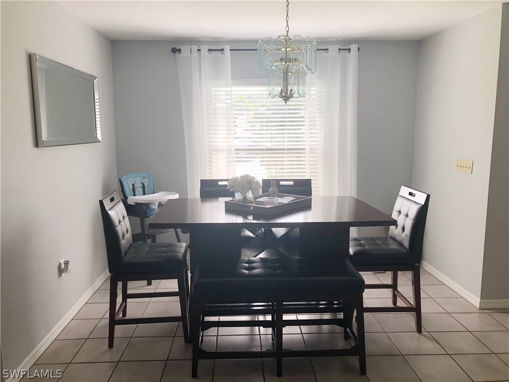 606 Robert Avenue Lehigh Acres, FL 33936 - Photo 3 of 14 a view of a dining room with furniture