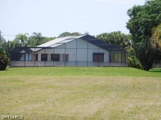 606 Robert Avenue Lehigh Acres, FL 33936 - Photo 6 of 14 a view of a house with a backyard