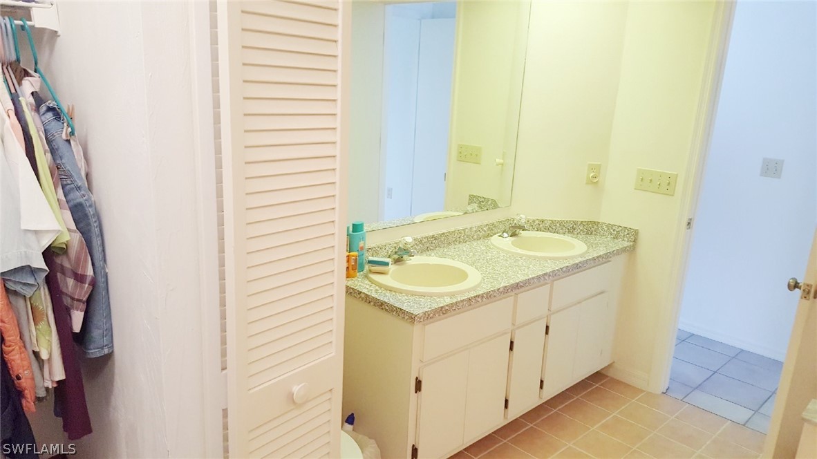 606 Robert Avenue Lehigh Acres, FL 33936 - Photo 9 of 14 a bathroom with a sink and a mirror