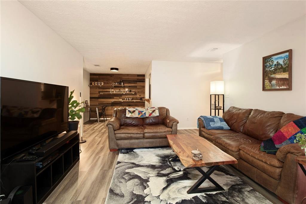 310 Natchez Trace Atlanta, GA 30350 - Photo 14 of 55 a living room with furniture and a flat screen tv