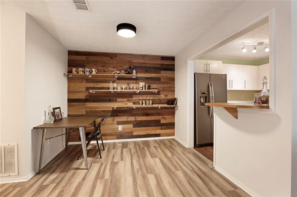 310 Natchez Trace Atlanta, GA 30350 - Photo 15 of 55 a kitchen with stainless steel appliances a refrigerator and a stove top oven