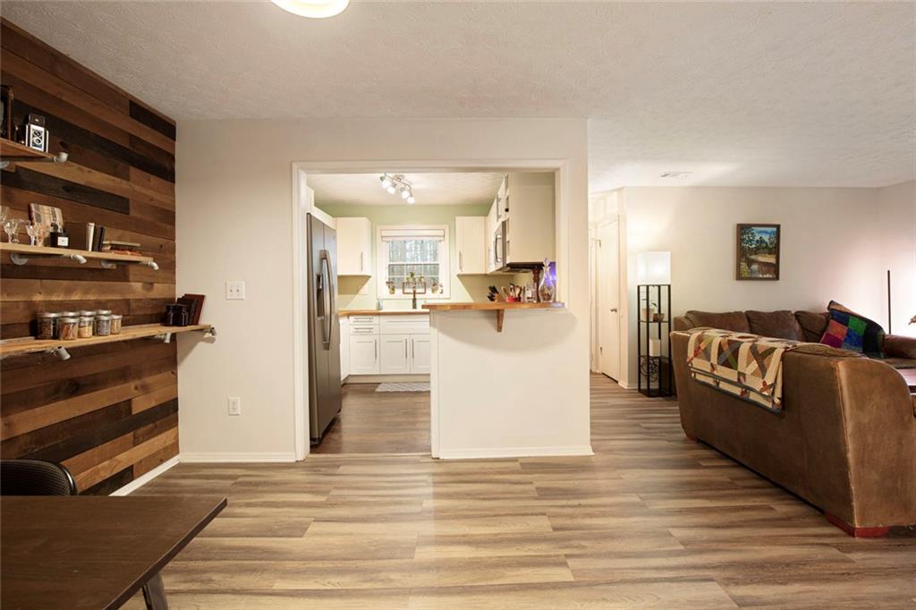 310 Natchez Trace Atlanta, GA 30350 - Photo 16 of 55 a living room with furniture and a kitchen area