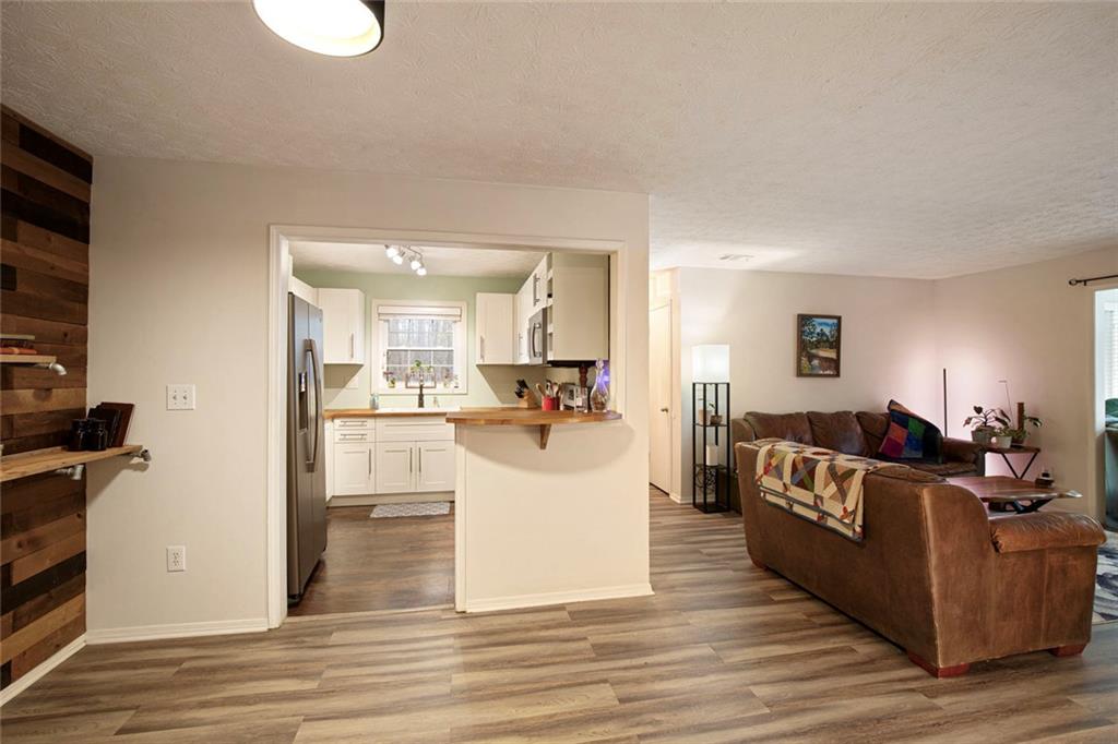 310 Natchez Trace Atlanta, GA 30350 - Photo 17 of 55 a living room with furniture and a wooden floor