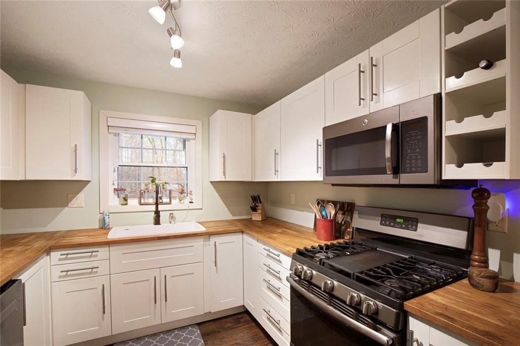 310 Natchez Trace Atlanta, GA 30350 - Photo 20 of 55 a kitchen with stainless steel appliances granite countertop a stove and a sink