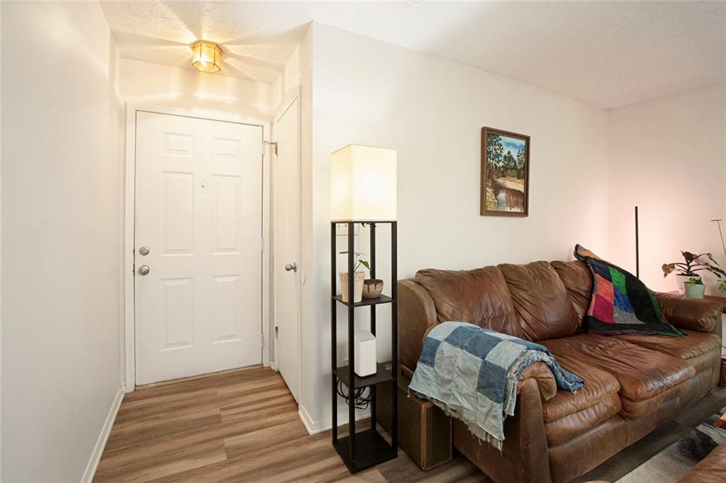 310 Natchez Trace Atlanta, GA 30350 - Photo 5 of 55 a living room with furniture and a wooden floor