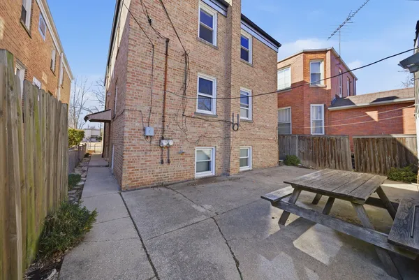 a view of a patio with a table and chairs
