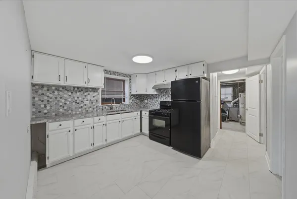 a kitchen with granite countertop cabinets and refrigerator