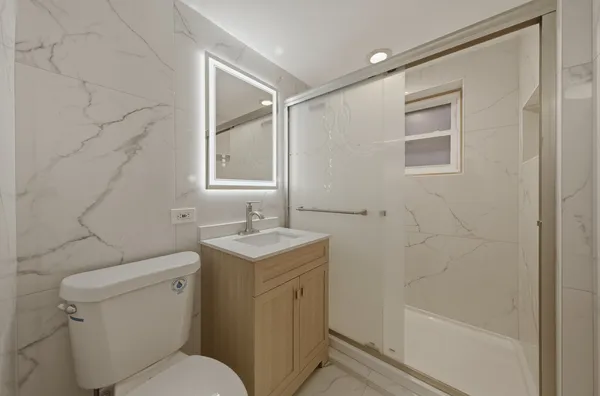 a bathroom with a toilet sink and shower