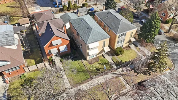 an aerial view of a house with a yard