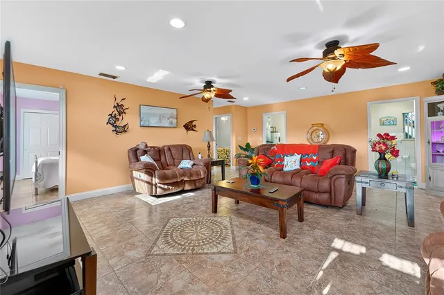a living room with furniture a rug and a chandelier