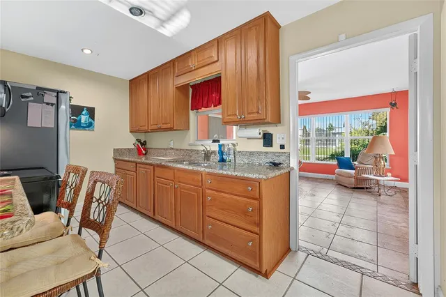 a kitchen with granite countertop a sink and cabinets