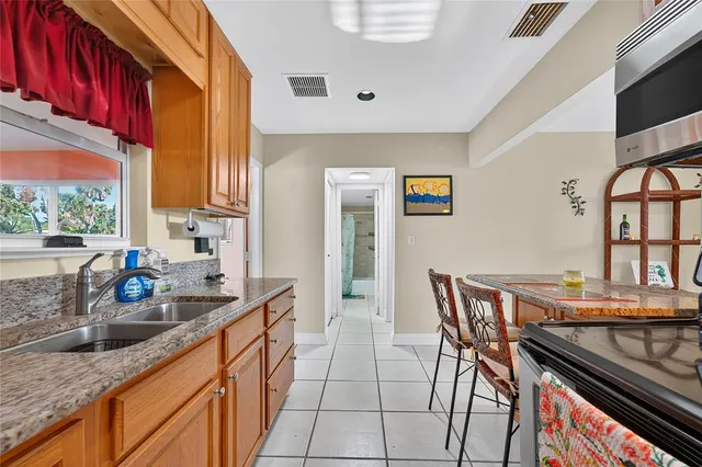 a kitchen with stainless steel appliances granite countertop a sink and a stove