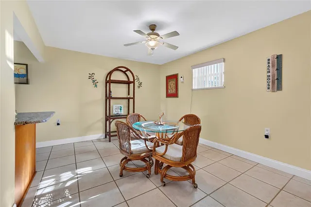 a view of a dining room with furniture and chandelier fan