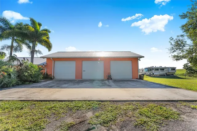 a view of a house with a backyard and a yard