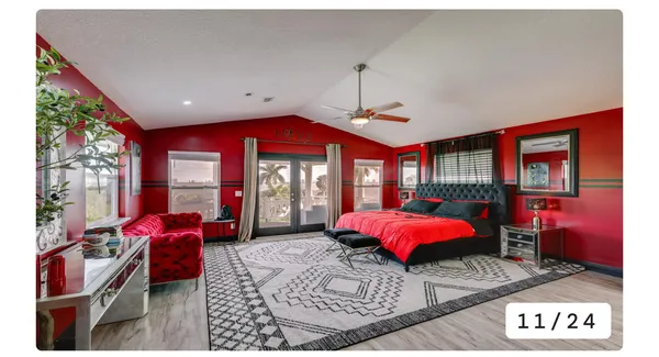 a living room with furniture a chandelier and large window
