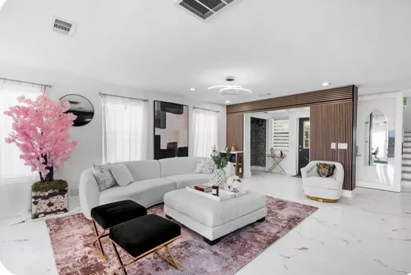 a living room with furniture and wooden floor