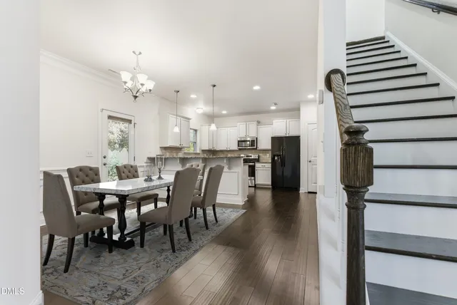 a view of kitchen with granite countertop cabinets and refrigerator