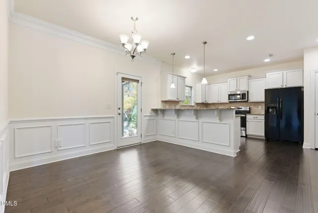a kitchen with cabinets appliances a sink and a counter top space