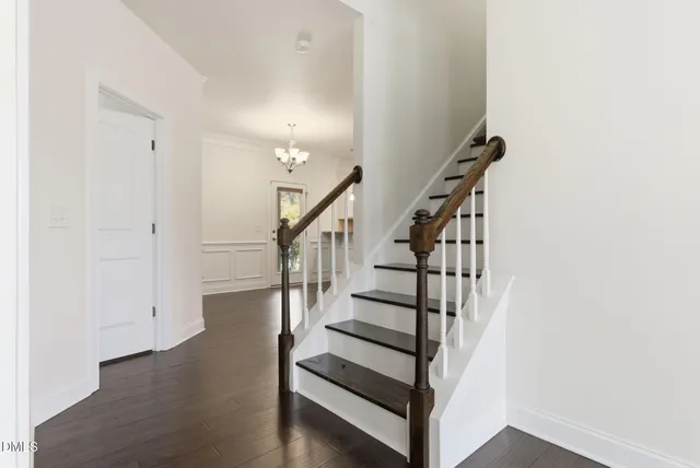 a bedroom with a large bed couch and windows