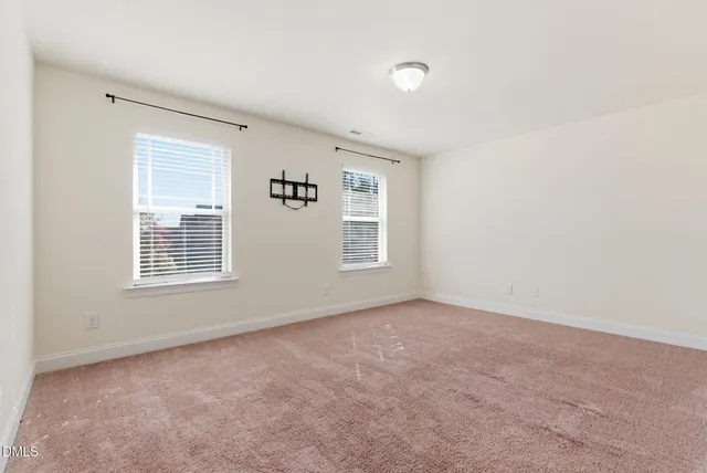 a spacious bedroom with a bed and a chandelier