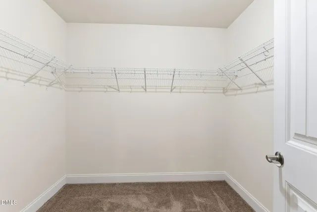 an empty room with closet area