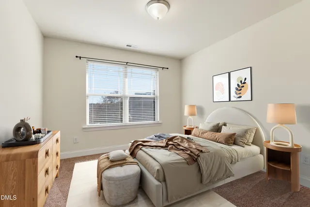 an empty room with a window and a ceiling fan