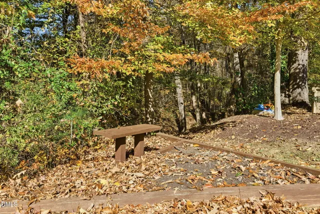 an aerial view of residential house with outdoor space and trees