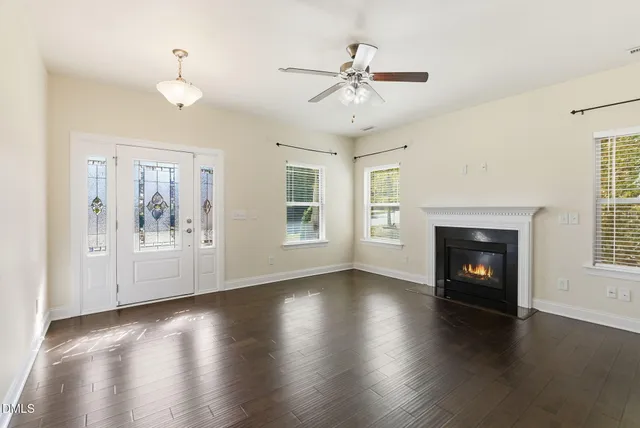 a living room with furniture a fireplace and a large mirror