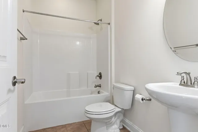 a room with a table chairs and a wooden floor