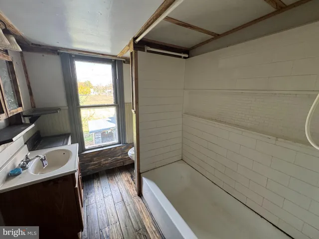 a bathroom with a shower and a sink