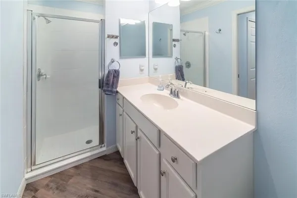 a bathroom with a double vanity sink mirror and shower