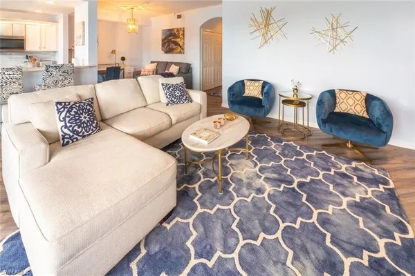 a living room with furniture and a floor to ceiling window
