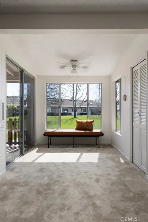 an empty room with large windows