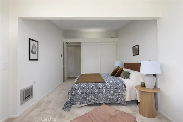 a bedroom with a bed and a lamp