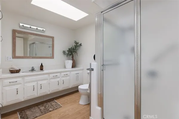 a bathroom with a double vanity sink a toilet and a mirror