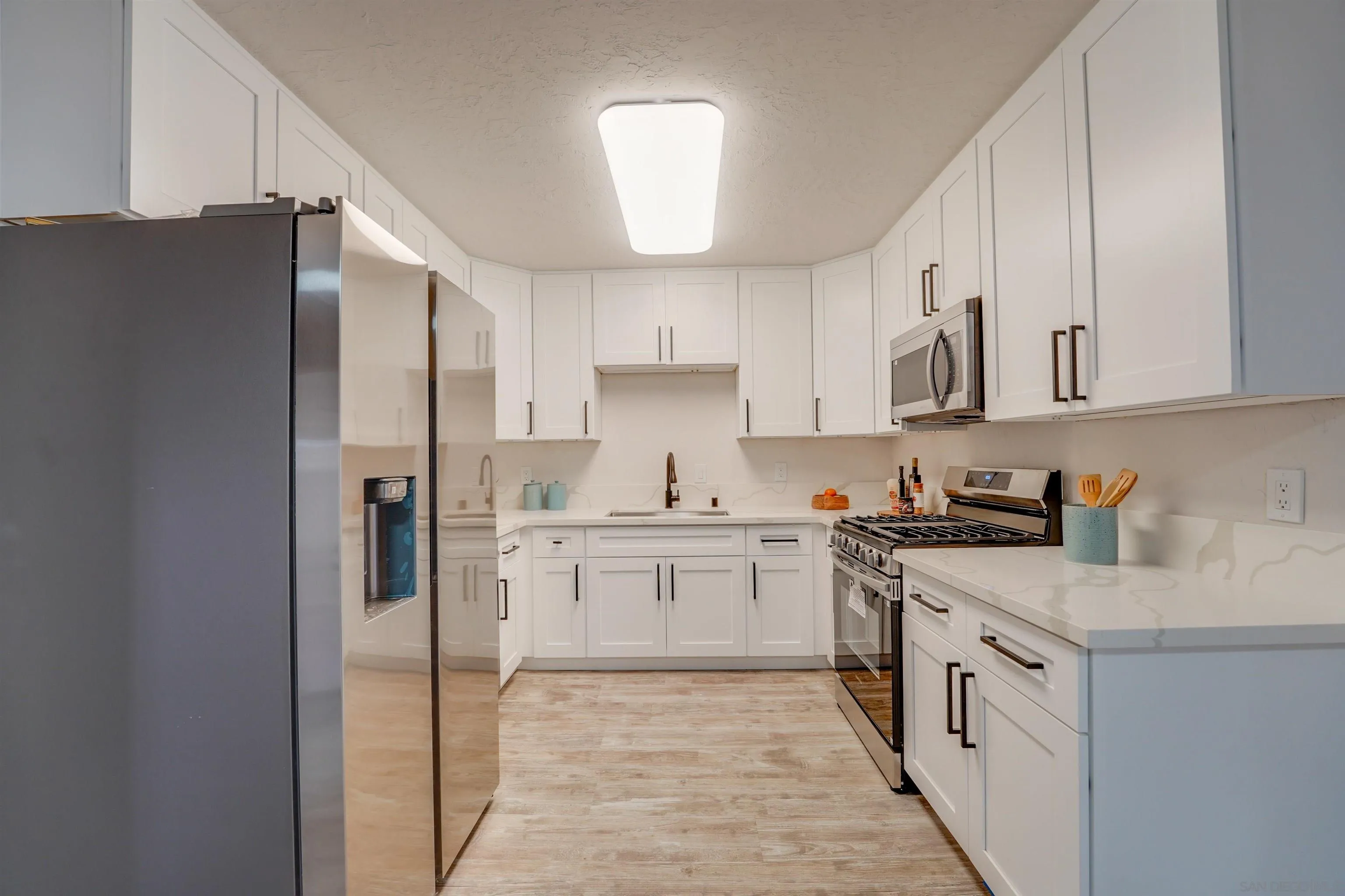 674 Palomar Avenue El Cajon, CA 92020 - Photo 18 of 56 a kitchen with stainless steel appliances granite countertop a refrigerator sink and cabinets