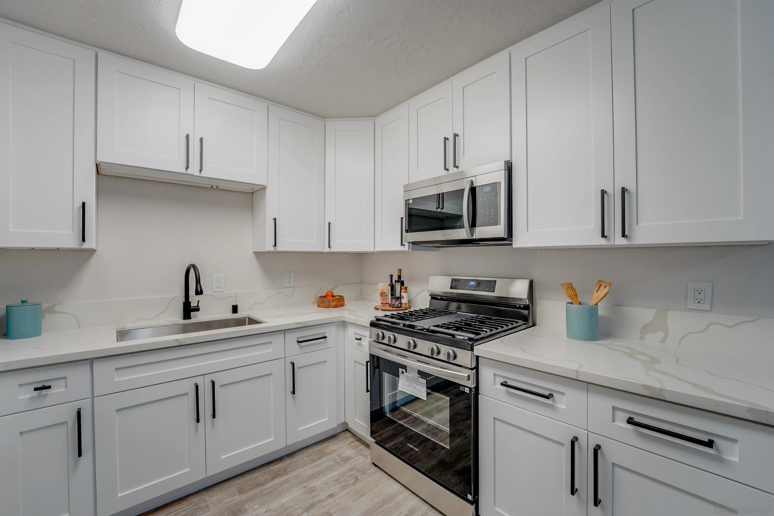 674 Palomar Avenue El Cajon, CA 92020 - Photo 19 of 56 a kitchen with white cabinets and white appliances