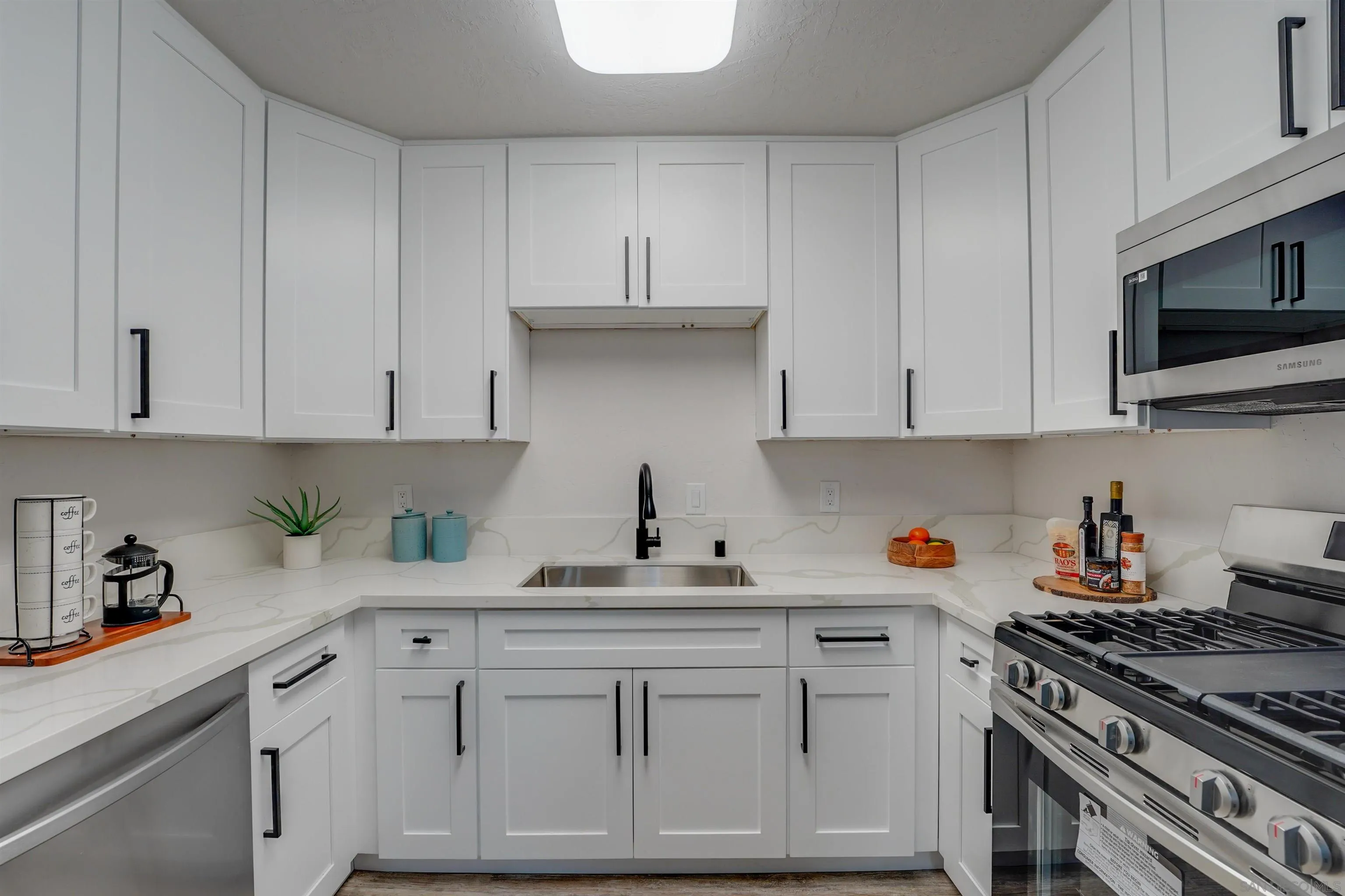 674 Palomar Avenue El Cajon, CA 92020 - Photo 20 of 56 a kitchen with white cabinets and appliances