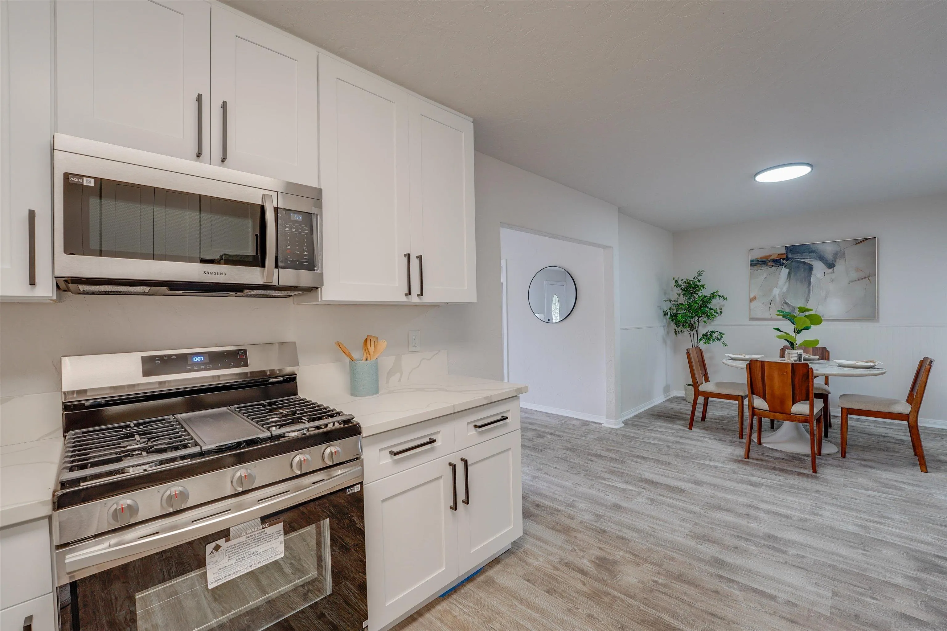 674 Palomar Avenue El Cajon, CA 92020 - Photo 21 of 56 a kitchen with stainless steel appliances a stove microwave and cabinets