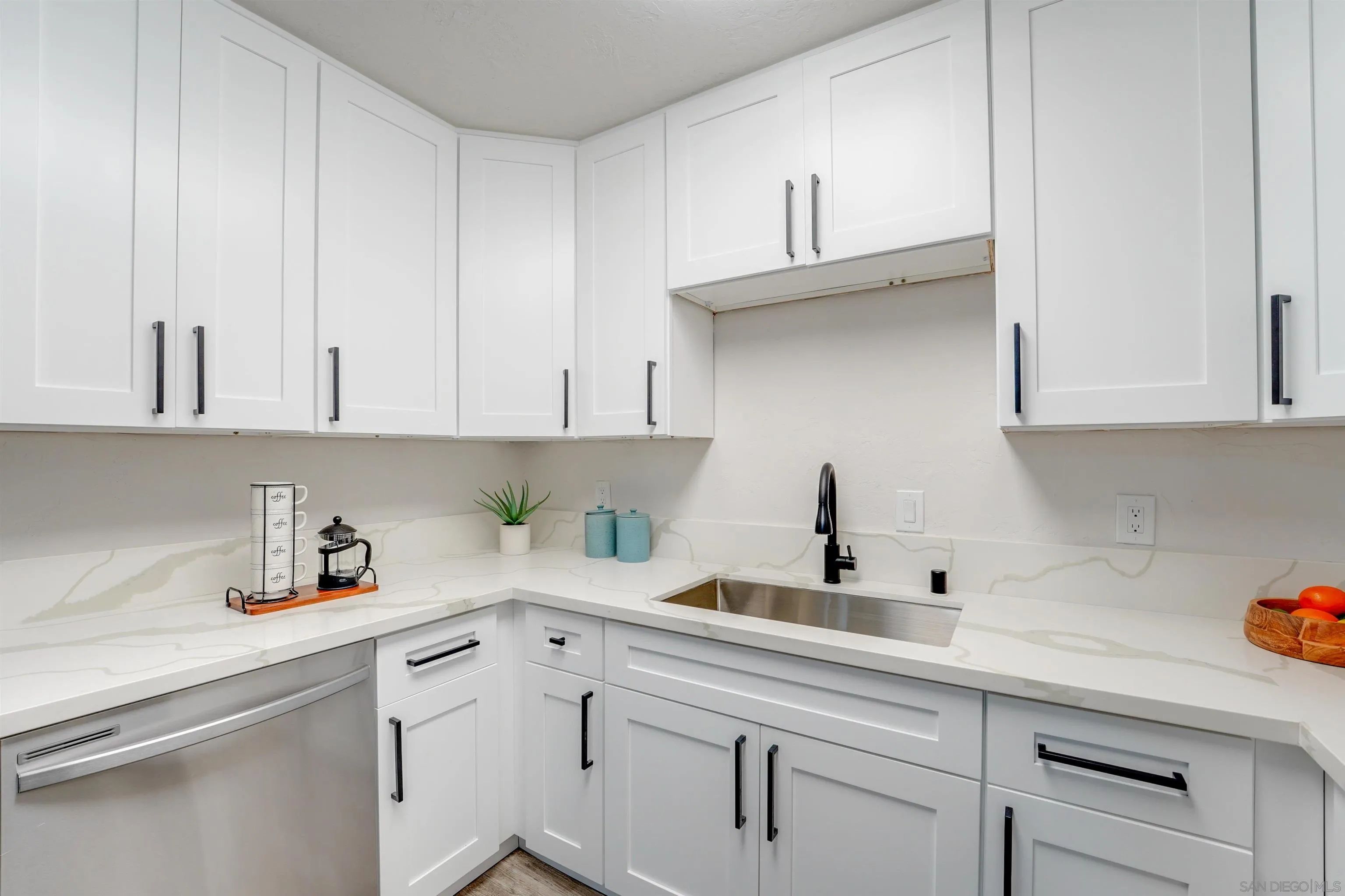 674 Palomar Avenue El Cajon, CA 92020 - Photo 22 of 56 a kitchen with white cabinets and a sink