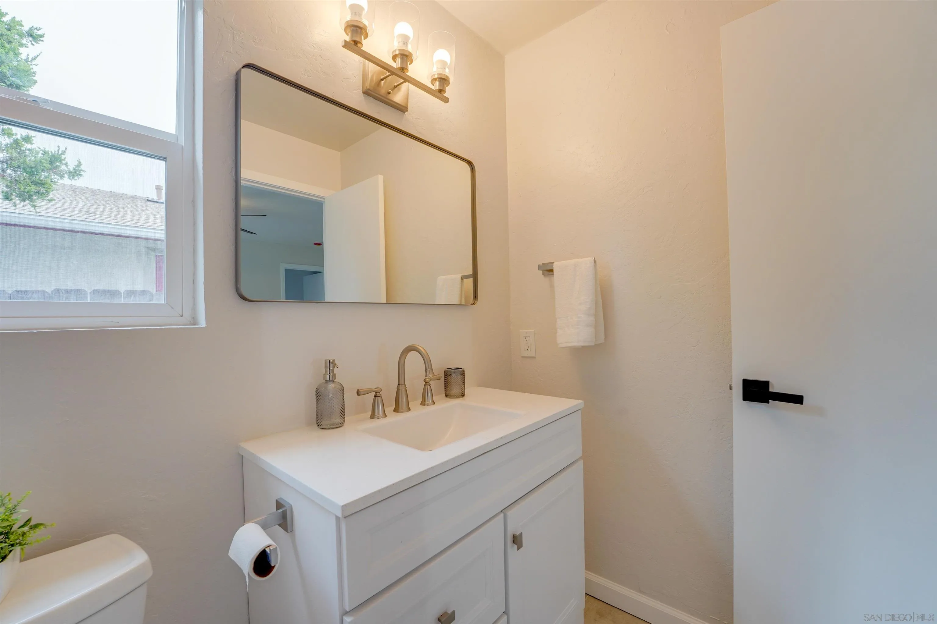 674 Palomar Avenue El Cajon, CA 92020 - Photo 35 of 56 a bathroom with a sink vanity and mirror